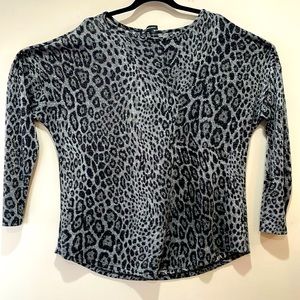 Silver threads woven throughout leopard print INC